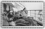 Passengers sit on the deck of the Lafayette during their voyage to the United States.