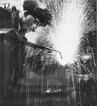 A prisoner welds metal at a Slovak labor camp.