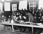 Chief defense attorney, Douglas Bates, examines evidence with his co-counsel in the first Dachau trial.