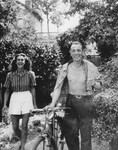 A Jewish dancer in hiding walks down a tree lined path with an unidentified man.