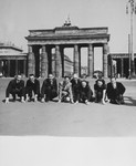 A company of French singers and dancers poses in front of the Brandenburg Gate while on a performance tour in Germany.