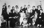 Portrait of a Polish Jewish family at a wedding.

Pictured are Hanka Wajcblum (seated in front), Estusia Wajcblum (seated second from right), Rebeka (Jaglom) Wajcblum (back row, left), and Sabina Wacjblum (back row, third from left).