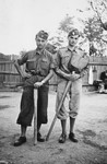 Two members of a Hungarian forced labor battalion pose holding a pick and shovel in Oradea, where they are accompanying the Hungarian army's advance into Transylvania.
