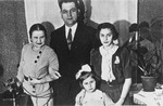 Portrait of a Polish Jewish family.  

Pictured are Estusia Wajcblum (far right), her cousin's daughter Yanka (front), Yanka's governess (left), and an unknown man.