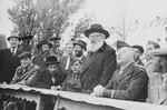 Rabbi Isaac Herzog speaks from a podium during an official visit to the Neu Freimann displaced persons' camp.
