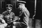 Two SS officers meet during the dedication of the new SS hospital in Auschwitz.