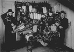 Rabbi Lifszyc (left) and another man pose in front of a cabinet full of Torah scrolls that were smuggled out of Suwalki.