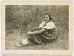 A young girl sits on a grassy field.

Pictured is Marta Rein.