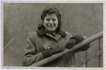 Close-up portrait of a Jewish woman wearing a yellow star and leaning on a railing in the Lodz ghetto.