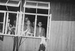 Survivors look out the window of the hospital barracks of the Buchenwald concentration camp.