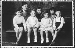 Studio portrait of seven Jewish cousins taken during the Passover holiday.