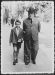 Sergio Minerbi walks down the streets of Warsaw with his Grandfather Chaim Benjamin Ginzburg.