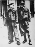 Close-up portrait of two young Jews living on the Aryan side of Warsaw and wearing suits made from German blankets.