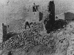 Polish workmen dismantle the wall of the Warsaw ghetto a few months after its destruction.