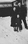A German-Jewish family poses in the snow outside one of the barracks of the Westerbork camp.