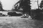 View of a large pile of prisoner uniforms in the newly liberated Dachau concentration camp.