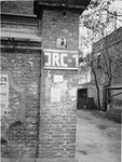 View of the exterior of a brick building painted with the initials IRC outside a heim on Ward Road in Shanghai.