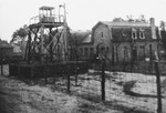 View of the watch tower and barbed wire fence surrounding the Beverloo internment camp in Leopoldsburg, Belgium.