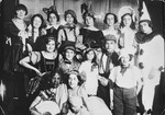 A large group of German and Jewish friends pose together during a costume party.
