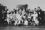 Children in a Czech kindergarten pose for a group portrait in costumes.