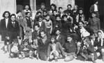 Group portrait of Jewish children and adults outside the synagogue in Marseilles where an American Jewish chaplain is organizing Passover religious services.
