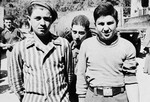 Close-up portrait of three of the Buchenwald boys in Marseilles prior to their departure to Palestine [probably on board the Mataroa].