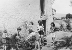 Jewish children gather up sticks outside an OSE children's home [perhaps La Forge in Fontenay-aux-Roses].