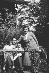 A Czech-Jewish couple poses in their garden with their two young sons.