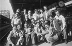 Group portrait of young Jewish survivors at a train station in Switzerland.
