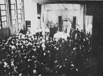 A large crowd attends a memorial service for the first anniversary of Kristallnacht in an auditorium in Shanghai.