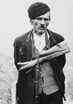 Close-up portrait of a partisan with a gun.

The original Waffen-SS caption reads, "Einsatz Montenegro.