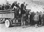 Men (likely Serbian partisans) arrested by the Prinz Eugen Division are forced to exit the back of an open truck.