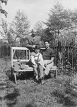 A Polish Jewish family poses on an outdoor bench on a farm outside of Krakow shortly before the outbreak of World War II.