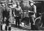 Four SS officers including Commandant Hermann Pister have a conversation on the grounds of the Hinzert concentration camp (a sub-camp of Buchenwald).