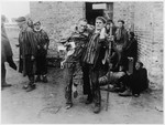Enfeebled survivors of the Woebbelin concentration camp await transportation to hospitals for medical attention.