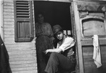 A Romani couple poses in the doorway of their caravan.