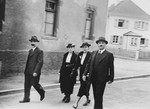 Two Jewish couples walk down Muggensturmstrasse in Breisach, Germany on their way to the synagogue.