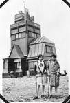 Hildegard Wolff (left) poses with a friend in front of a weather station on the top of the Schneekoppe.