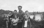 Group portrait of five children and a man ouside the Masgelier children's home in France.