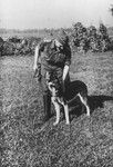 SS officer Karl Hoecker pets his dog.

The original caption reads "Mein Schaeferhund ,Favorit'" [My Shephard dog ,Favorit'].