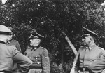 SS officers Oswald Pohl (left) and Ernst Schmauser (center) visit Auschwitz.