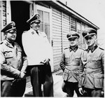 SS-Obersturmbannfuehrer Arthur Roedl (in white), the commandant of Gross-Rosen, in the camp with three members of the SS staff.