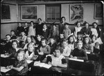 Group portrait of young children and teachers in a class in Amsterdam.