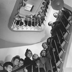 Young children pose for a group photograph on the stairwell of an unidentified OSE post-war children's home.