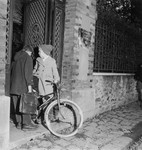 Two young children, one with a bicycle, stand outside La Source, a progressive school [probably supported by OSE] after the war.