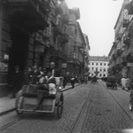 A Jewish woman rides in a rickshaw down Karmelicka Street in the Warsaw ghetto.