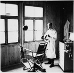A dentist stands in his office on the grounds of the Gross-Rosen concentration camp.