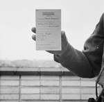 Mme. Margueritte Paquet shows a warrant for her execution issued in the Breendonck internment camp.