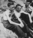 Three malnourished British POWs sit on the grounds of Stalag XIB [Eleven B], a camp outside Fallingbostel.