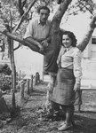 A young Jewish couple poses by a tree in the Landsberg DP camp.